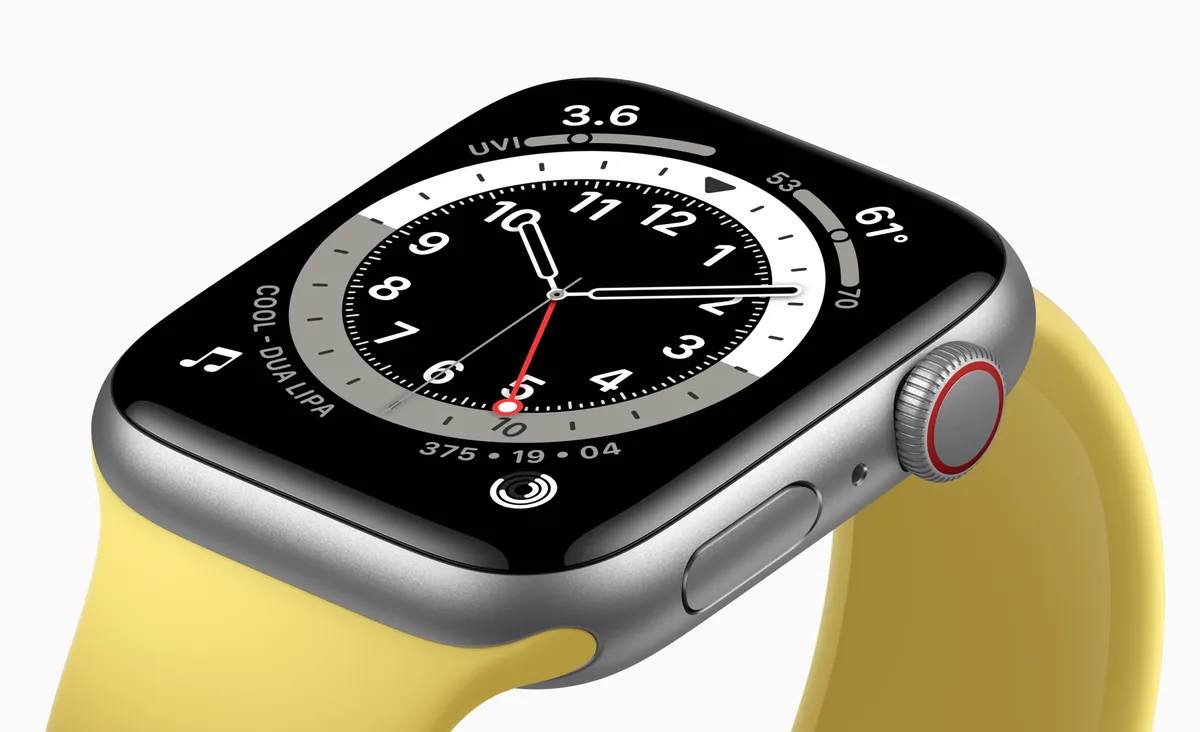 Apple Watch SE with a silver aluminum case and yellow band showing a numeral watch face