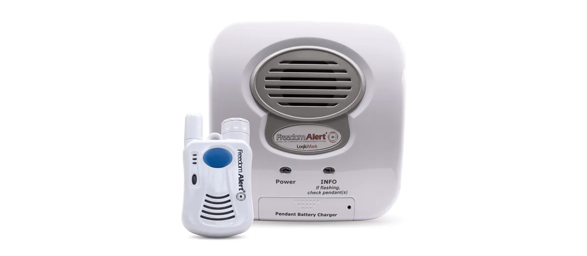 LogicMark Freedom Alert landline pendant next to its base station